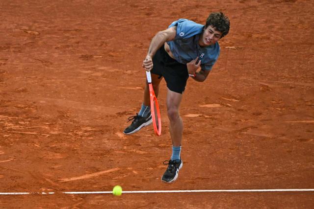 Italy's Flavio Cobolli serves to Germany's Alexander Zverev during their 2026 ATP Tour Madrid Open tennis tournament quarter-final singles match at the Caja Magica in Madrid, on April 30, 2026. (Photo by Javier SORIANO / AFP)