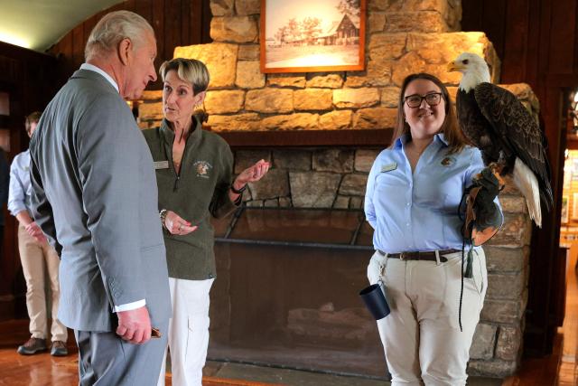 Haley Williamson (R), animal program manager, holds Eagle “Buddy” as Britain's King Charles III and President of Wildlife Center Of Virginia Meg Gammage-Tucker look on during a visit to the Dickey Ridge Visitor Center at Shenandoah National Park in Front Royal, Virginia, on April 30, 2026. (Photo by Chip Somodevilla / POOL / AFP)