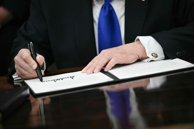 US President Donald Trump signs an executive order in the Oval Office at the White House in Washington, DC on April 30, 2026. (Photo by Brendan SMIALOWSKI / AFP)