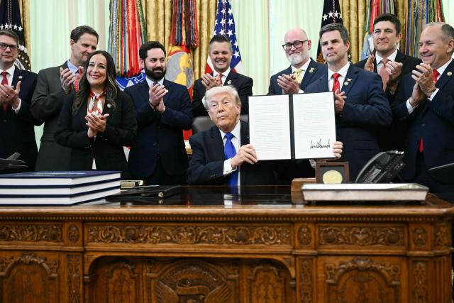 US President Donald Trump holds a signed executive order to expand retirement account access for workers in the Oval Office at the White House in Washington, DC on April 30, 2026. (Photo by Brendan SMIALOWSKI / AFP)