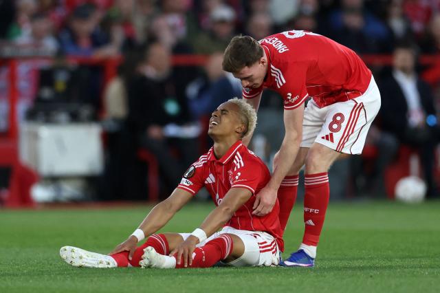 Nottingham Forest's English midfielder #08 Elliot Anderson (R) helps Nottingham Forest's English midfielder #21 Omari Hutchinson to his feet during the Europa League semi-final first-leg football match between Nottingham Forest and Aston Villa at The City Ground in Nottingham, central England, on April 30, 2026. (Photo by Darren Staples / AFP)