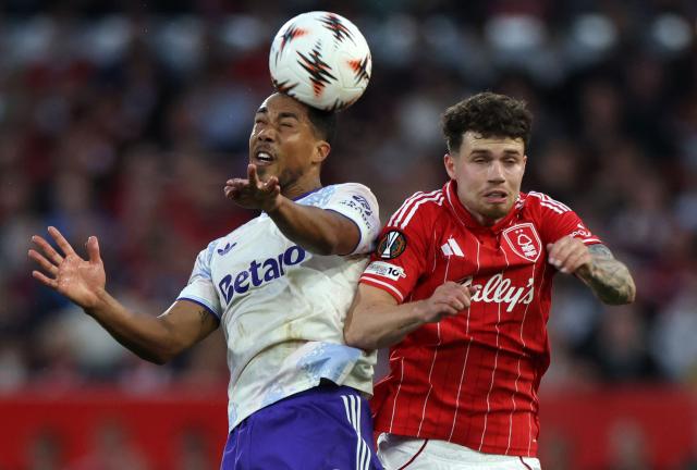 Aston Villa's Belgian midfielder  #08 Youri Tielemans jumps above Nottingham Forest's Welsh defender #03 Neco Williams to header the ball during the UEFA Europa League semi-final first-leg football match between Nottingham Forest and Aston Villa at The City Ground in Nottingham, central England, on April 30, 2026. (Photo by Darren Staples / AFP)