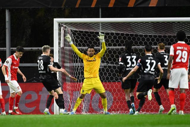 Freiburg's German goalkeeper #01 Noah Atubolu (C) celebrates making a save on a penalty kick during the UEFA Europa League semi final first leg football match between SC Braga and SC Freiburg at Municipal stadium of Braga on April 30, 2026. (Photo by Miguel RIOPA / AFP)