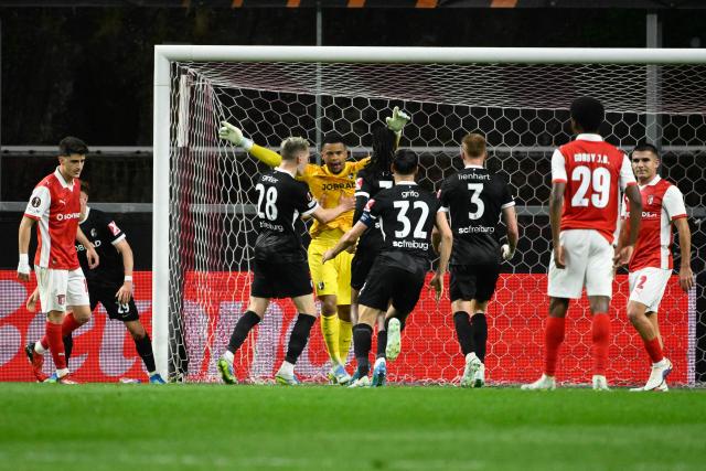 Freiburg's German goalkeeper #01 Noah Atubolu (C) celebrates making a save on a penalty kick during the UEFA Europa League semi final first leg football match between SC Braga and SC Freiburg at Municipal stadium of Braga on April 30, 2026. (Photo by Miguel RIOPA / AFP)