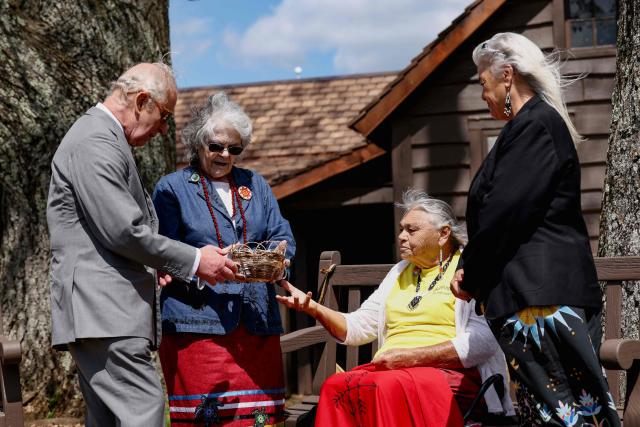 Britain's King Charles III receives a gift from members of the Monacan Indian Nation during a visit at Dickey Ridge Visitor Center as he visits Shenandoah National Park in Front Royal, Virginia, on April 30, 2026. (Photo by Kevin Lamarque / POOL / AFP)