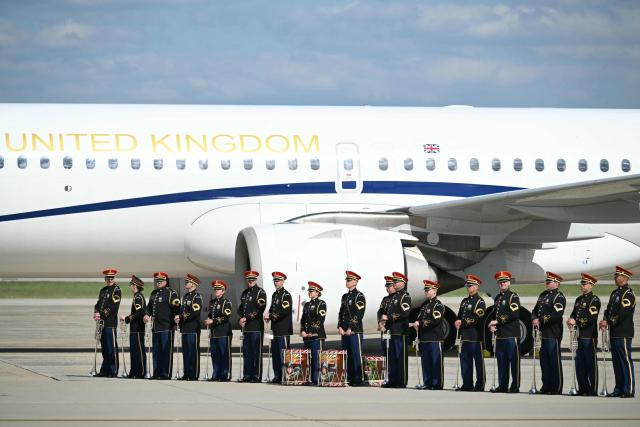 An honor guard stands next to the Britain's King Charles III and Queen Camilla's plane prior to their arrival at Joint Base Andrews in Maryland, on April 30, 2026. King Charles III and Queen Camilla are wrapping up their visit to the United States and will head to Bermuda next. (Photo by SAUL LOEB / POOL / AFP)