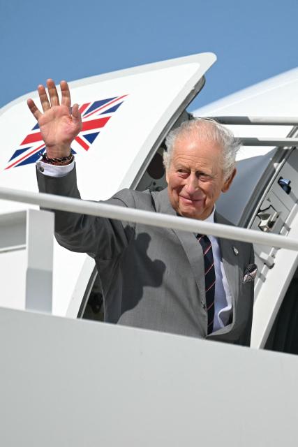 Britain's King Charles III waves as he boards his plane at Joint Base Andrews in Maryland, on April 30, 2026. King Charles III and Queen Camilla are wrapping up their visit to the United States and will head to Bermuda next. (Photo by SAUL LOEB / POOL / AFP)
