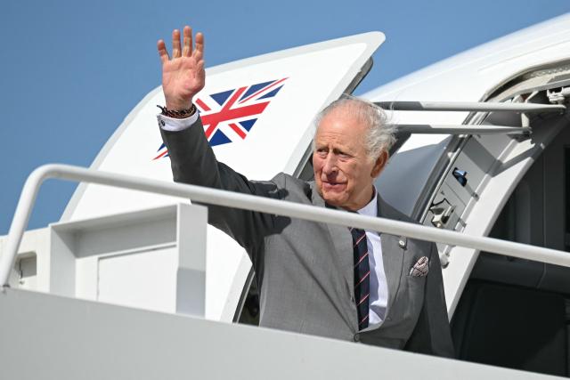 Britain's King Charles III waves as he boards his plane at Joint Base Andrews in Maryland, on April 30, 2026. King Charles III and Queen Camilla are wrapping up their visit to the United States and will head to Bermuda next. (Photo by SAUL LOEB / POOL / AFP)