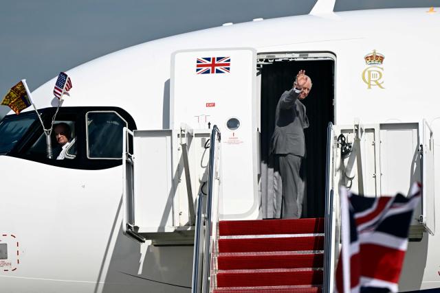 Britain's King Charles III waves goodbye as he boards his plane at Joint Base Andrews in Maryland, on April 30, 2026. King Charles III and Queen Camilla are wrapping up their visit to the United States and will head to Bermuda next. (Photo by Kent NISHIMURA / AFP)