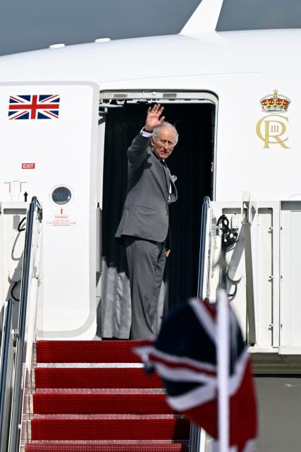 Britain's King Charles III waves goodbye as he boards his plane at Joint Base Andrews in Maryland, on April 30, 2026. King Charles III and Queen Camilla are wrapping up their visit to the United States and will head to Bermuda next. (Photo by Kent NISHIMURA / AFP)