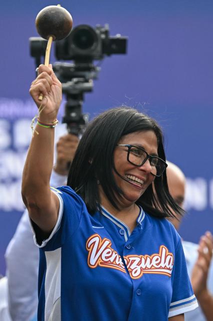 Venezuela's acting president Delcy Rodriguez holds a maraca during a march calling for the lifting of all US sanctions in Caracas on April 30, 2026. Delcy Rodriguez announced on April 30 a 26% wage increase to the so-called "integral minimum income," raising it from 190 dollars to 240 dollars per month, the first adjustment since Nicolas Maduro's fall. (Photo by Juan BARRETO / AFP)