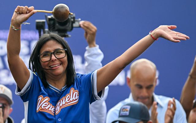 Venezuela's acting president Delcy Rodriguez holds a maraca during a march calling for the lifting of all US sanctions in Caracas on April 30, 2026. Delcy Rodriguez announced on April 30 a 26% wage increase to the so-called "integral minimum income," raising it from 190 dollars to 240 dollars per month, the first adjustment since Nicolas Maduro's fall. (Photo by Juan BARRETO / AFP)