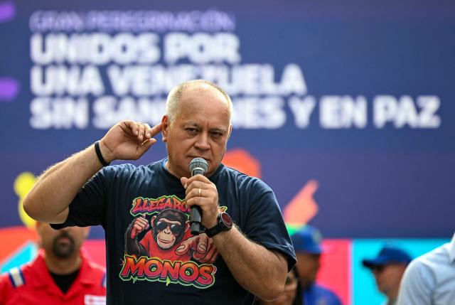 Venezuela's Interior Minister Diosdado Cabello gestures during a march calling for the lifting of all US sanctions in Caracas on April 30, 2026. Venezuela's acting president Delcy Rodriguez announced on April 30 a 26% wage increase to the so-called "integral minimum income," raising it from 190 dollars to 240 dollars per month, the first adjustment since Nicolas Maduro's fall. (Photo by Juan BARRETO / AFP)