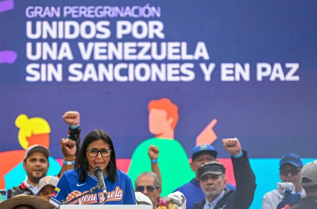 Venezuela's acting president Delcy Rodriguez speaks during a march calling for the lifting of all US sanctions in Caracas on April 30, 2026. Delcy Rodriguez announced on April 30 a 26% wage increase to the so-called "integral minimum income," raising it from 190 dollars to 240 dollars per month, the first adjustment since Nicolas Maduro's fall. (Photo by Juan BARRETO / AFP)