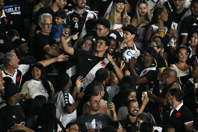 Vasco da Gama fans take a selfie with the ball before returning it to the field during the Copa Sudamericana group stage football match between Brazil's Vasco da Gama and Paraguay's Olimpia at the Sao Januario stadium in Rio de Janeiro, Brazil on April 30, 2026. (Photo by MAURO PIMENTEL / AFP)