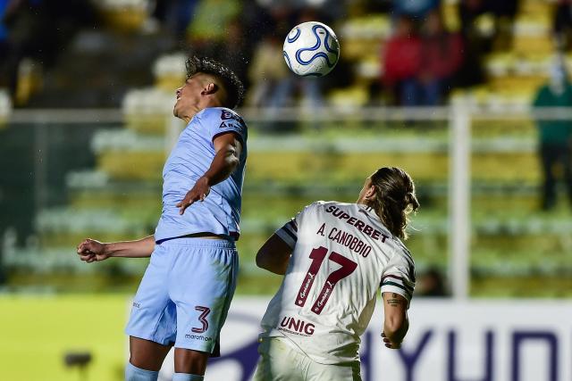 Bolivar's defender #03 Xavier Arreaga and Fluminense's Uruguayan midfielder #17 Agustin Canobbio fight for the ball during the Copa Libertadores group stage football match between Bolivia's Bolivar and Brazil's Fluminense at the Hernando Siles stadium in La Paz on April 30, 2026. (Photo by Jorge BERNAL / AFP)