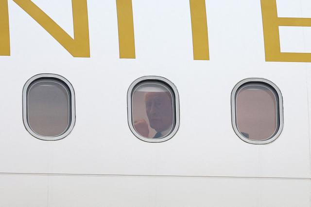 Britain's King Charles III is seen inside his plane upon arrival to the L.F. Wade International Airport in Hamilton, Bermuda, on April 30, 2026. King Charles III is in Bermuda for his first visit to a British Overseas Territory as Sovereign. (Photo by Chris Jackson / POOL / AFP)