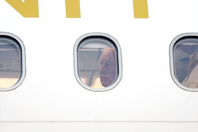 Britain's King Charles III is seen inside his plane upon arrival to the L.F. Wade International Airport in Hamilton, Bermuda, on April 30, 2026. King Charles III is in Bermuda for his first visit to a British Overseas Territory as Sovereign. (Photo by Chris Jackson / POOL / AFP)