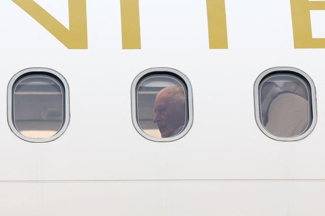 Britain's King Charles III is seen inside his plane upon arrival to the L.F. Wade International Airport in Hamilton, Bermuda, on April 30, 2026. King Charles III is in Bermuda for his first visit to a British Overseas Territory as Sovereign. (Photo by Chris Jackson / POOL / AFP)