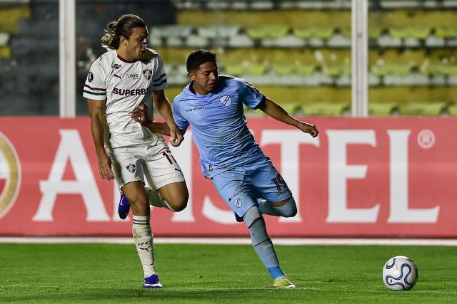 Fluminense's Uruguayan midfielder #17 Agustin Canobbio (L) and Bolivar's midfielder John Garcia (R) fight for the ball during the Copa Libertadores group stage football match between Bolivia's Bolivar and Brazil's Fluminense at the Hernando Siles stadium in La Paz on April 30, 2026. (Photo by Jorge BERNAL / AFP)