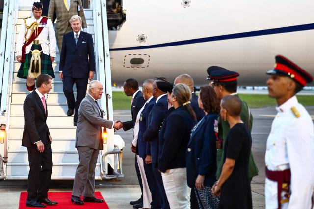 Britain's King Charles III is greeted by Bermuda's Premier David Burt upon his arrival to the L.F. Wade International Airport in Hamilton, Bermuda, on April 30, 2026. King Charles III is in Bermuda for his first visit to a British Overseas Territory as Sovereign. (Photo by Henry NICHOLLS / AFP)