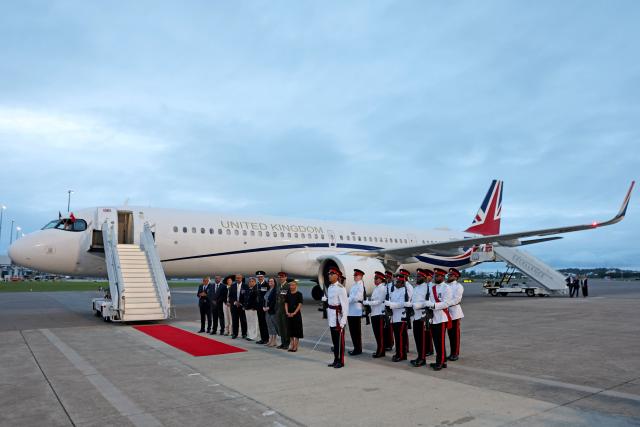 Government officials and members of the Royal Bermuda Regiment assemble to welcome Britain's King Charles III as he arrives at L.F. Wade International Airport in Hamilton, Bermuda, on April 30, 2026. King Charles III is in Bermuda for his first visit to a British Overseas Territory as Sovereign. (Photo by Chris Jackson / POOL / AFP)