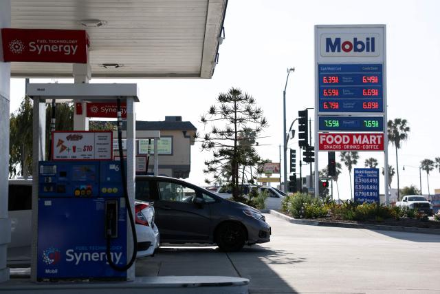 Vehicles sit parked at fuel pumps as regular gasoline prices above $6 per gallon and diesel prices above $7 per gallon are displayed outside a Mobil gas station in Redondo Beach, California on April 30, 2026. Energy costs have surged since the near-total closure of the Strait of Hormuz, through which about a fifth of the world's oil and gas usually passes, following the outbreak of the US-Israeli war against Iran. (Photo by Patrick T. Fallon / AFP)