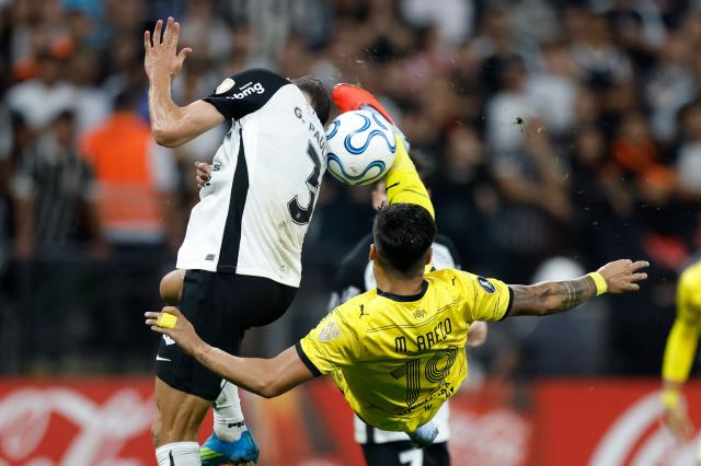 Penarol's forward #19 Matias Arezo performs a bicycle kick past Corinthians' defender #03 Gabriel Paulista during the Copa Libertadores group stage football match between Brazil's Corinthians and Uruguay's Penarol at the Neo Quimica Arena stadium in Sao Paulo, Brazil on April 30, 2026. (Photo by Miguel SCHINCARIOL / AFP)