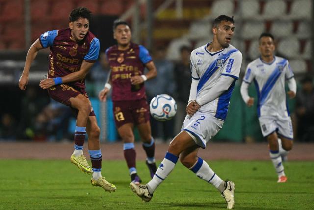 Macara's Argentine forward #07 Federico Paz (L) kicks the ball past Alianza Atletico's Argentine defender #02 Roman Gaston Suarez (R) during the Copa Sudamericana group stage football match between Peru's Alianza Atletico and Ecuador's Macara, at the Miguel Grau stadium in Bellavista, Callao district, Peru, on April 30, 2026. (Photo by ERNESTO BENAVIDES / AFP)