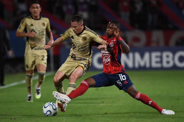 Cusco's Argentine forward #26 Nicolas Silva and Independiente Medellin's midfielder #16 Halam Loboa fight for the ball during the Copa Libertadores group stage football match between Colombia's Independiente Medellin and Peru's Cusco FC at the Atanasio Girardot stadium in Medellin, Antioquia department, Colombia on April 30, 2026. (Photo by Jaime SALDARRIAGA / AFP)