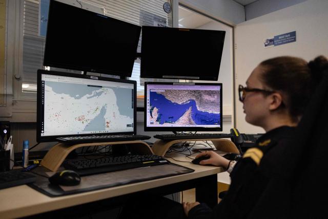 A worker of the Maritime International Cooperation and Awareness (MICA) center looks at screens at the MICA in Brest, western France on April 27, 2026. Attacks on oil tankers in the Strait of Hormuz, piracy off the coast of Somalia, drug trafficking: with their eyes fixed on screens crammed with maps, a dozen sailors at the MICA Centre monitor the worlds maritime hotspots in real time.
Since the start of the war in the Middle East, triggered by Israeli-American strikes on Iran on February 28, 2026, this French centre of expertise in maritime security, attached to the French Navy, has been providing invaluable support to civilian vessels and crews stranded in the Persian Gulf. (Photo by Fred TANNEAU / AFP)