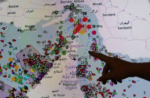 French Commandant Thomas Scalabre points towards the positions of ships on the Strait of Hormuz on a screen at the MICA center (Maritime Information and Cooperation and Awareness) in Brest, western France on April 27, 2026. Attacks on oil tankers in the Strait of Hormuz, piracy off the coast of Somalia, drug trafficking: with their eyes fixed on screens crammed with maps, a dozen sailors at the MICA Centre monitor the worlds maritime hotspots in real time.
Since the start of the war in the Middle East, triggered by Israeli-American strikes on Iran on February 28, 2026, this French centre of expertise in maritime security, attached to the French Navy, has been providing invaluable support to civilian vessels and crews stranded in the Persian Gulf. (Photo by Fred TANNEAU / AFP)
