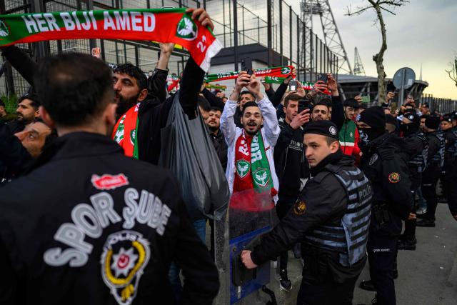 Amedspor's fans cheer their team on outside the Esenler Erokspor Stadium ahead of the Trendyol League football match between Amedspor and Esenler Erokspor in the Esenler district of Istanbul, on April 9, 2026. Amedspor, a club from Diyarbakir, the "capital" of Turkey's predominantly Kurdish southeast, can secure promotion to the first division on May 2, 2026, an unprecedented prospect that has sparked a wave of enthusiasm among the country's millions of Kurds. (Photo by Yasin AKGUL / AFP)