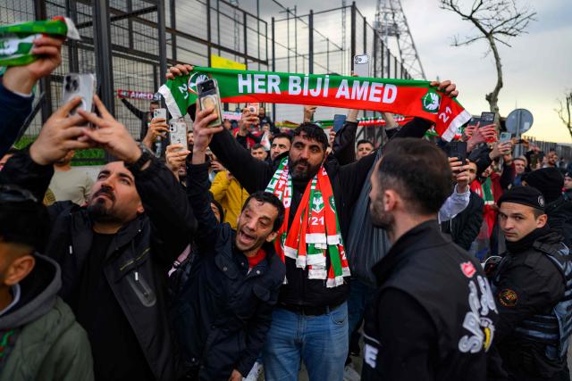 Amedspor's fans cheer their team on outside the Esenler Erokspor Stadium ahead of the Trendyol League football match between Amedspor and Esenler Erokspor in the Esenler district of Istanbul, on April 9, 2026. Amedspor, a club from Diyarbakir, the "capital" of Turkey's predominantly Kurdish southeast, can secure promotion to the first division on May 2, 2026, an unprecedented prospect that has sparked a wave of enthusiasm among the country's millions of Kurds. (Photo by Yasin AKGUL / AFP)