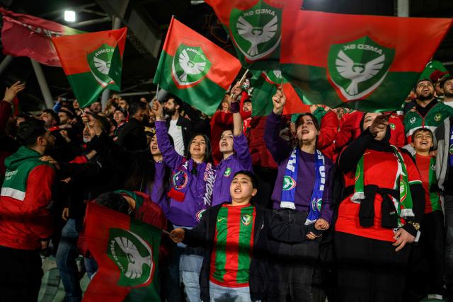 Amedspor's supporters cheer their team on from the stands during the Trendyol League football match between Amedspor and Esenler Erokspor at the Esenler Erokspor Stadium, in the Esenler district of Istanbul, on April 9, 2026. Amedspor, a club from Diyarbakir, the "capital" of Turkey's predominantly Kurdish southeast, can secure promotion to the first division on May 2, 2026, an unprecedented prospect that has sparked a wave of enthusiasm among the country's millions of Kurds. (Photo by Yasin AKGUL / AFP)