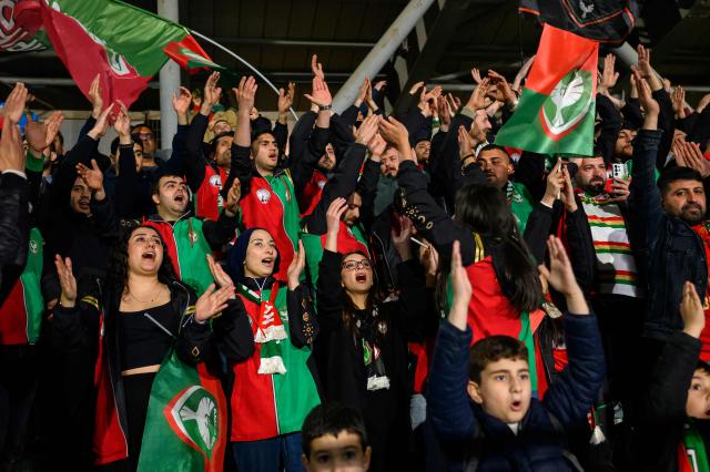 Amedspor's supporters cheer their team on from the stands during the Trendyol League football match between Amedspor and Esenler Erokspor at the Esenler Erokspor Stadium, in the Esenler district of Istanbul, on April 9, 2026. Amedspor, a club from Diyarbakir, the "capital" of Turkey's predominantly Kurdish southeast, can secure promotion to the first division on May 2, 2026, an unprecedented prospect that has sparked a wave of enthusiasm among the country's millions of Kurds. (Photo by Yasin AKGUL / AFP)