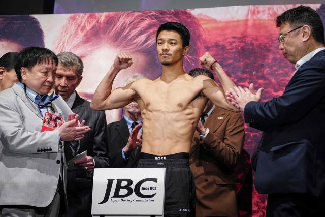 Japanese boxer Junto Nakatani (C) poses for photographs during a weigh-in ahead of his May 2 boxing match with Naoya Inoue in Tokyo on May 1, 2026. (Photo by Yuichi YAMAZAKI / AFP)