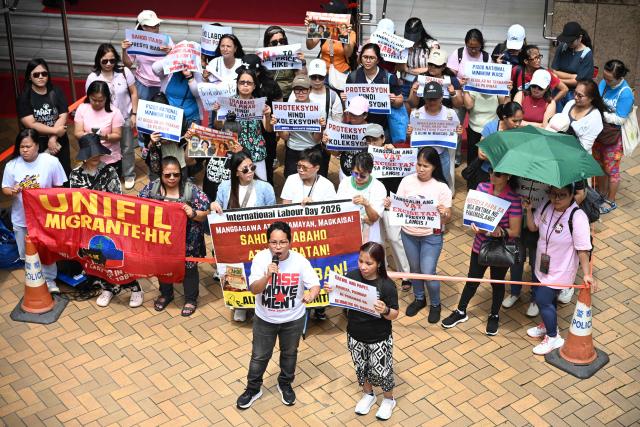 Members of the Asian Migrants' Coordinating Body (AMCB), the biggest coalition of migrant domestic workers' associations and unions of various nationalities, take part in a rally on Labour Day in Hong Kong on May 1, 2026. (Photo by Peter PARKS / AFP)