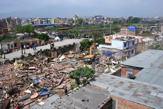 Heavy construction equipment is used to demolish squatter settlements near the Bagmati River in Kathmandu on May 1, 2026. Nepali authorities has been demolishing informal settlements to thousands of people along river banks of the capital, despite criticism from rights groups. (Photo by PRAKASH MATHEMA / AFP)