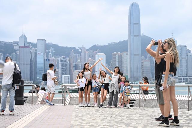 Tourists visit Victoria Harbour during China's Labour Day golden week holiday in Hong Kong on May 1, 2026. (Photo by Peter PARKS / AFP)