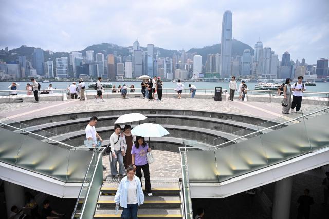 Tourists visit Victoria Harbour during China's Labour Day golden week holiday in Hong Kong on May 1, 2026. (Photo by Peter PARKS / AFP)