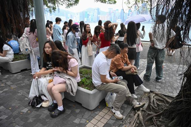 Tourists visit Victoria Harbour during China's Labour Day golden week holiday in Hong Kong on May 1, 2026. (Photo by Peter PARKS / AFP)