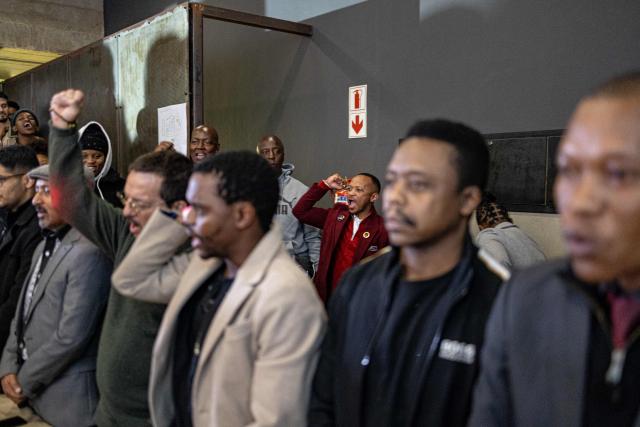 Attendees gesture at the launch of “Finishing What Was Started”, an event reflecting on the legacy of the June 1976 generation and a call to action for today’s youth, at the Hector Pieterson Museum in Soweto on April 30, 2026. (Photo by EMMANUEL CROSET / AFP)