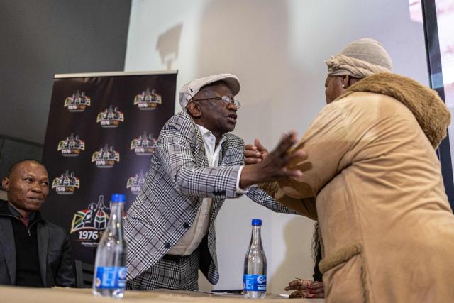 Antoinette Sithole (R), sister of Hector Pieterson, greets Seth Mazibuko (C), a fellow veteran of the June 16, 1976 Soweto Uprising, at the launch of “Finishing What Was Started”, an event reflecting on the legacy of the June 1976 generation and a call to action for today’s youth, at the Hector Pieterson Museum in Soweto on April 30, 2026. (Photo by EMMANUEL CROSET / AFP)
