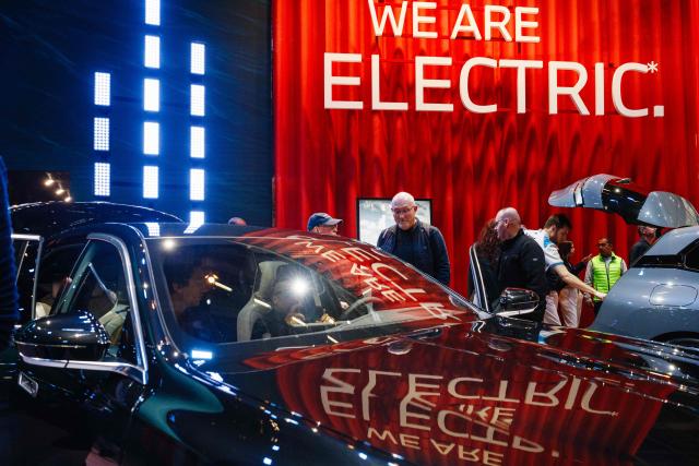 (FILES) Visitors look at a BMW i7 xDrive electric car presented at the Paris Motor Show at Paris Expo, Porte de Versailles in Paris on October 15, 2024. New electric car sales in France jumped 48 percent year-on-year in the first four months of the year to 148,302 units, even as the broader automotive market struggled, the automotive industry body PFA, which represents all carmakers, said on May 1, 2026. (Photo by Dimitar DILKOFF / AFP)