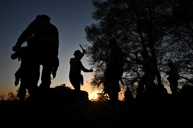 The Ashdown Forest Morris Men sing in May Day as they perform at sunrise in the Ashdown Forest, south of London on May 1, 2026. Historically, in rural Britain, May Day celebrations were associated with the fertility of spring and the start of summer. (Photo by Ben STANSALL / AFP)