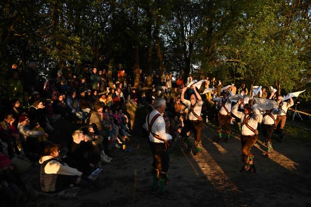 The Ashdown Forest Morris Men sing in May Day as they perform at sunrise in the Ashdown Forest, south of London on May 1, 2026. Historically, in rural Britain, May Day celebrations were associated with the fertility of spring and the start of summer. (Photo by Ben STANSALL / AFP)