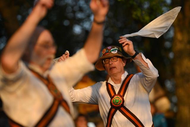 The Ashdown Forest Morris Men sing in May Day as they perform at sunrise in the Ashdown Forest, south of London on May 1, 2026. Historically, in rural Britain, May Day celebrations were associated with the fertility of spring and the start of summer. (Photo by Ben STANSALL / AFP)