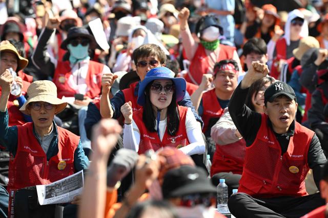 Trade union groups and labour activists shout slogans during a Labour Day rally calling for improved working conditions and rights in Seoul on May 1, 2026. (Photo by Jung Yeon-je / AFP)