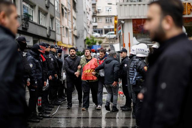 Turkish police detain a protestor during a May Day (Labour Day) rally, marking international Workers' Day, in Besiktas, a district of Istanbul, on May 1, 2026. (Photo by BERK OZKAN / AFP)